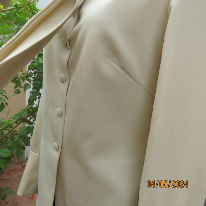 Smart rich cream 100% firm polyester long sleeve top/ Tie collar/Covered front buttons. Size 36.