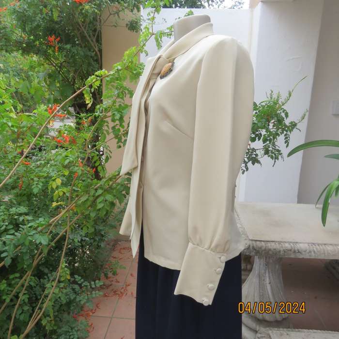 Smart rich cream 100% firm polyester long sleeve top/ Tie collar/Covered front buttons. Size 36.