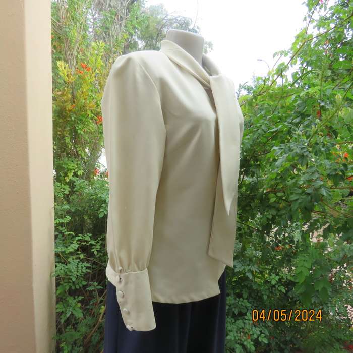 Smart rich cream 100% firm polyester long sleeve top/ Tie collar/Covered front buttons. Size 36.