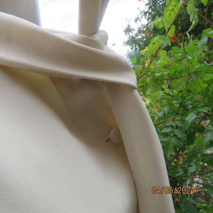 Smart rich cream 100% firm polyester long sleeve top/ Tie collar/Covered front buttons. Size 36.