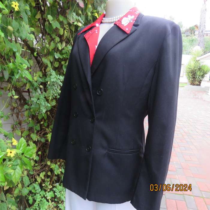 Elegant double breasted black long sleeve tailored poly/rayon jacket. Partly lined.By DIJON size 36.