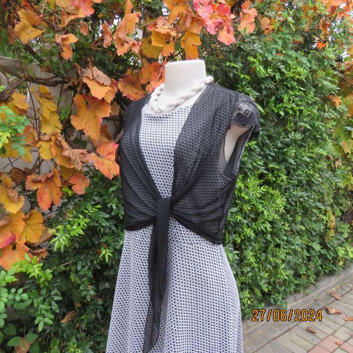 Handy crossover sheer polyester black bolero. Long straps to tie, Tiny lace capped sleeves. Size 38