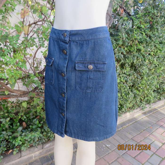 Button down blue jean knee length skirt in polycotton denim. Size 36. Front pockets. As new