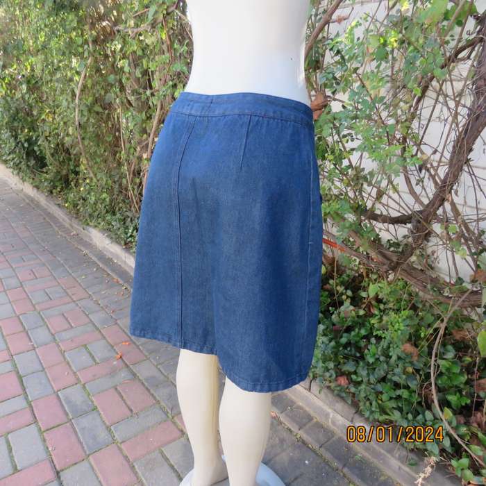 Button down blue jean knee length skirt in polycotton denim. Size 36. Front pockets. As new