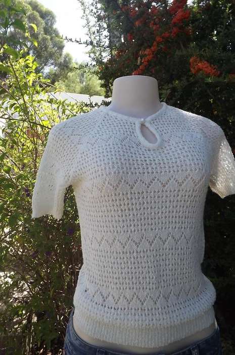 Beautiful knitted acrylic top in beige with lace pattern.Will fit 32/8. New condition