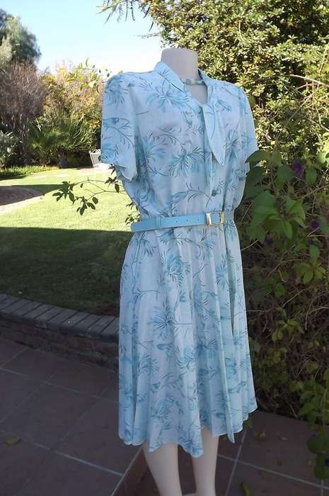 Vintage Delswa dress in size 44/20.Soft turquoise colours with floral pattern.Tie collar and button