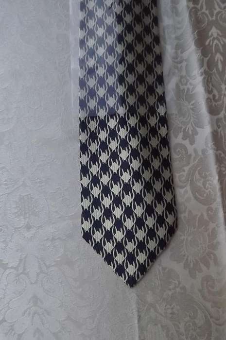 From Italy 100% silk tie in navy and cream diamond pattern.New.Width 8.75cm