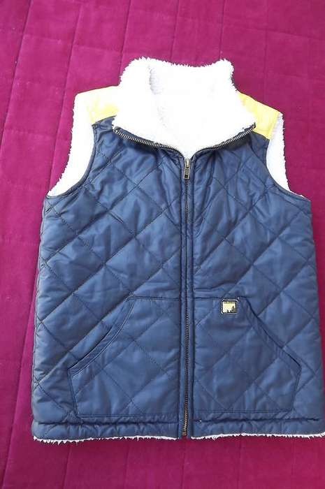 Warm polyester waistcoat with faux fur lining for boy of 5-6 years old by Woolworths.2 Front pockets
