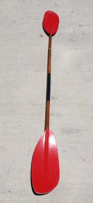 An incredible bright red rowing boat with a wooden oar in excellent condition | RS17