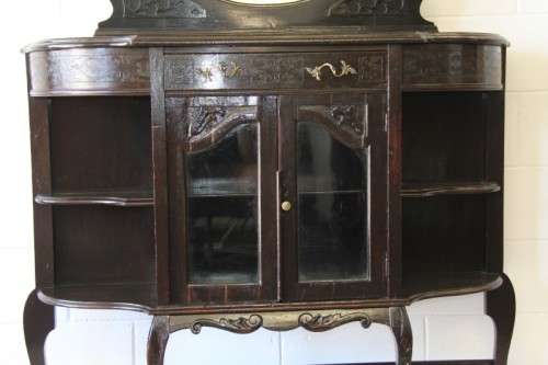 A magnificent display cabinet with a beveled mirror, cupboards and loads of shelf space