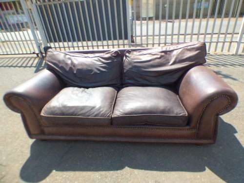 A stunning x-large modern styled brown genuine leather couch in great condition.