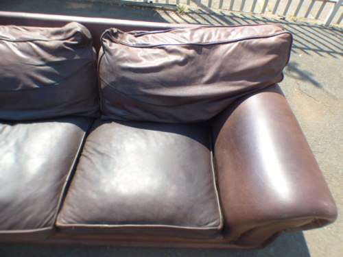 A stunning x-large modern styled brown genuine leather couch in great condition.