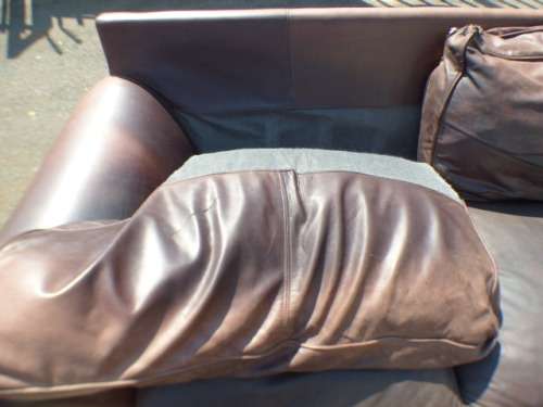 A stunning x-large modern styled brown genuine leather couch in great condition.