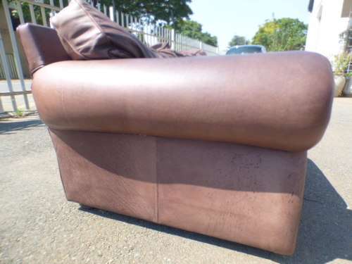 A stunning x-large modern styled brown genuine leather couch in great condition.