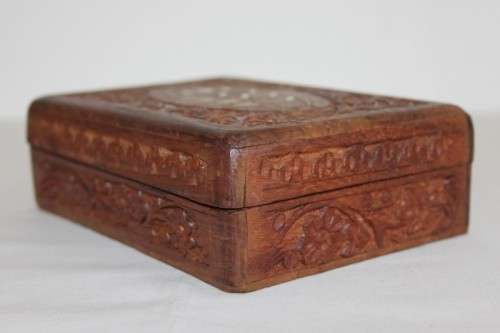A beautiful hand carved wooden playing card/ storage box with lovely detailing on it