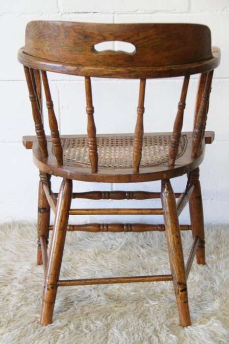 A magnificent Edwardian antique solid oak tub chair with a wicker bottom - very collectable!
