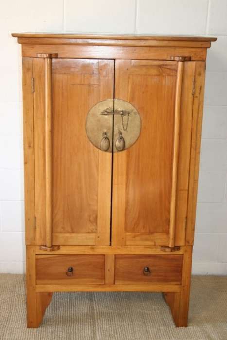 A magnificent Indonesian teak entertainment cabinet with traditional solid brass embellishments