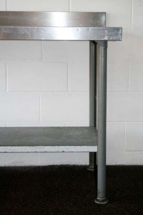 A fantastic (1.68m) stainless steel catering table with splash-back and galvanised storage shelf