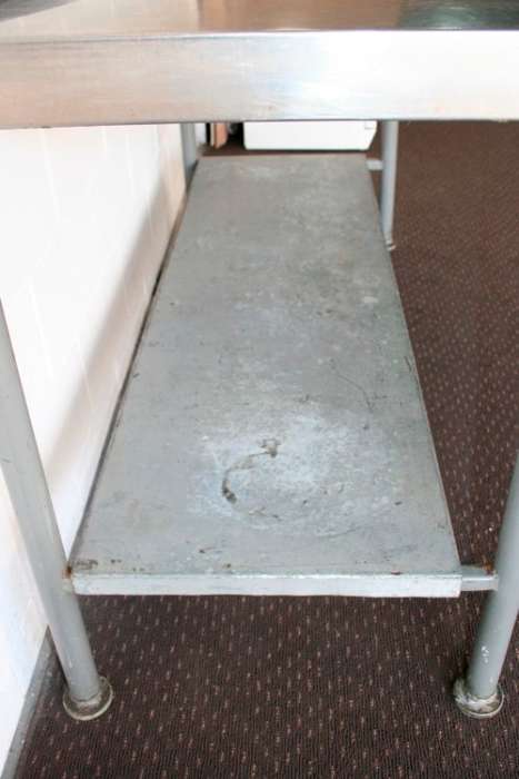 A fantastic (1.68m) stainless steel catering table with splash-back and galvanised storage shelf