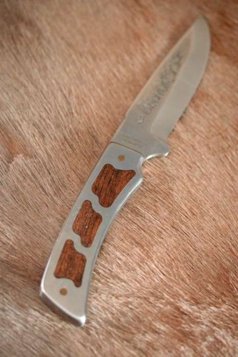 A fantastic "surgical steel" Torro Model AS1004 Hunter knife in its original leather sheath