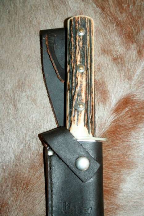 A superb original handmade German Solingen Inox Linder Bowie knife in its embossed leather scabbard