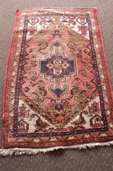 An awesome vintage/ antique? hand dyed Persian carpet (127cm x 80cm) with red and earthy tones