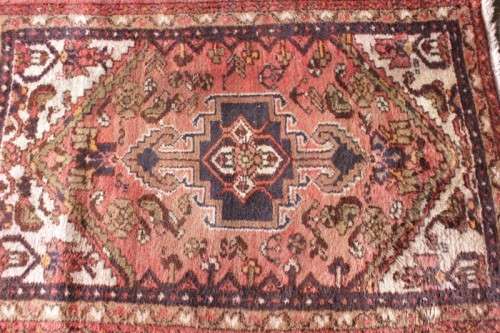 An awesome vintage/ antique? hand dyed Persian carpet (127cm x 80cm) with red and earthy tones