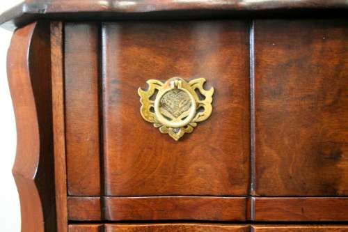 An exquisite vintage Imbuia 4-drawer chest of drawers with ornate handles and ample storage space