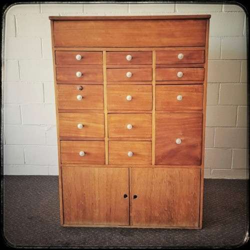 An awesome mid-century 14-drawer Apothecary cabinet with a double door cupboard and preparation top