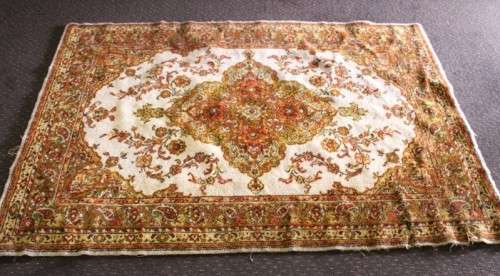 A vintage 189cm x 132cm Persian styled carpet w/ dark greens, marigold yellow, rust & earthy colours