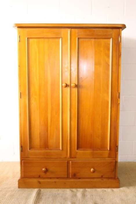 A stunning, well made double folding-door Yellow wood wardrobe with two storage drawers