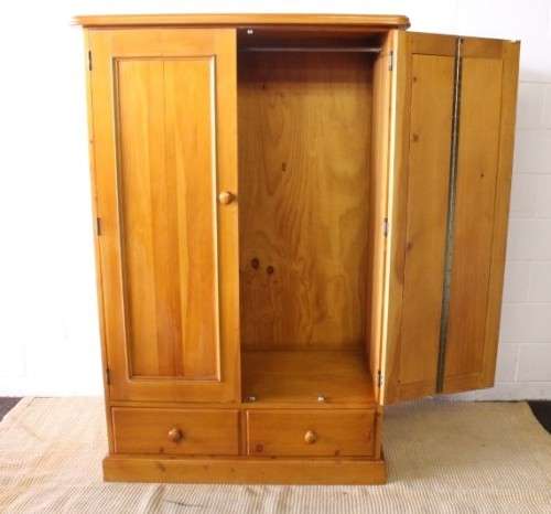 A stunning, well made double folding-door Yellow wood wardrobe with two storage drawers