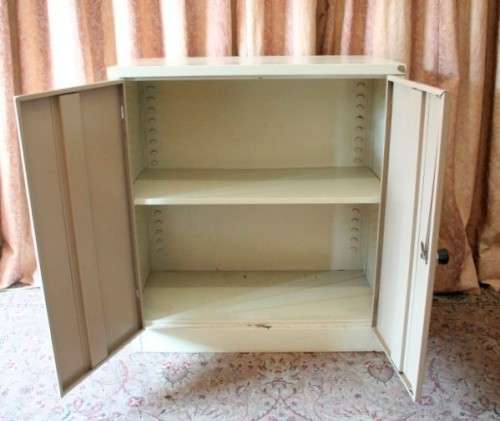 A sturdy metal multi purpose cabinet with a large cupboard, needs some tlc, perfect to paint!