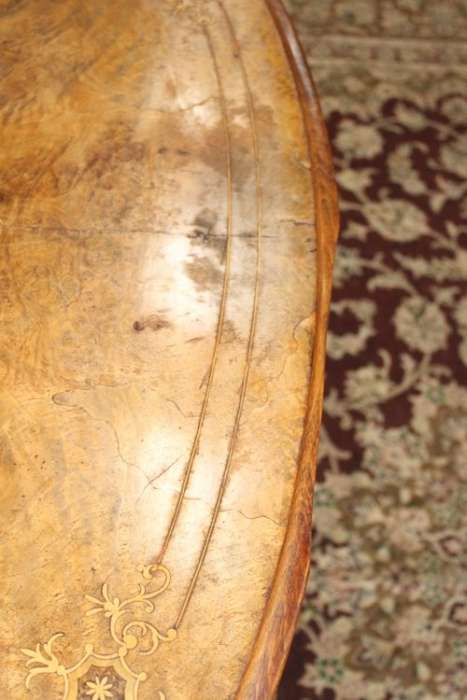 An incredible antique walnut & walnut burr carved loo table w/ marquetry inlay detailing on castors