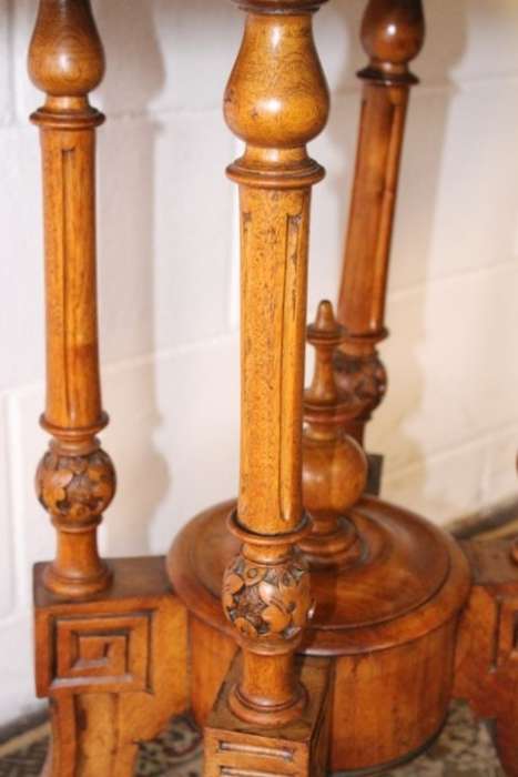 An incredible antique walnut & walnut burr carved loo table w/ marquetry inlay detailing on castors