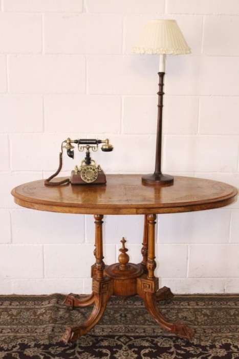 An incredible antique walnut & walnut burr carved loo table w/ marquetry inlay detailing on castors