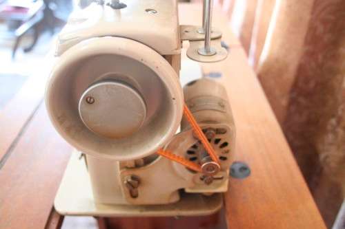 A vintage Empisal deluxe electric sewing machine in its original cabinet w/ accessories, working.