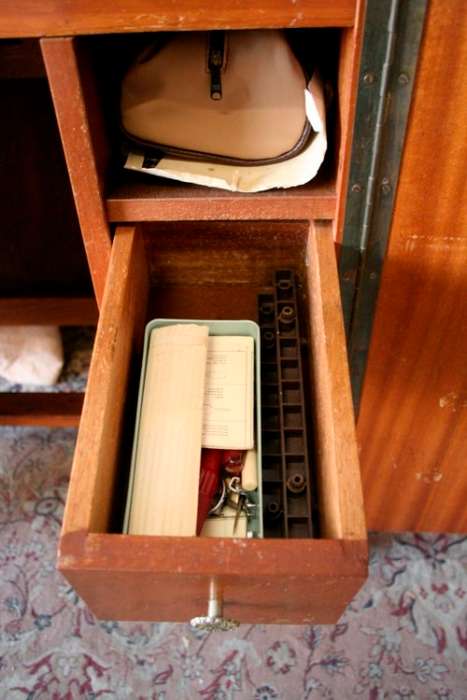 A vintage Empisal deluxe electric sewing machine in its original cabinet w/ accessories, working.