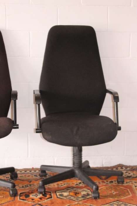 Two high-back office/ desk chairs; one is black the other is brown - one price for both