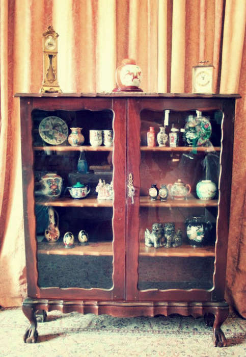 A beautifully made vintage solid Imbuia ball & claw two glass door showcase/ bookcase