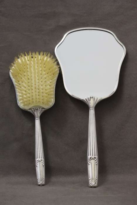 A beautiful antique vanity brush & mirror set w gorgeous pressed detailing.