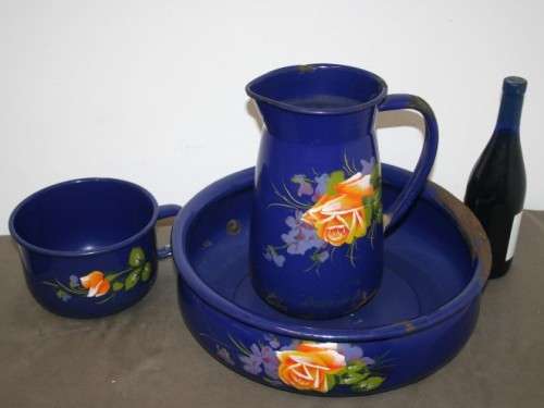 A wonderful vintage dark blue w/ hand painted flowers enamel wash basin, pitcher & chamber pot set.