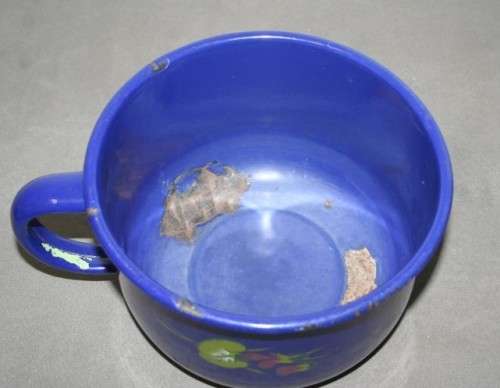 A wonderful vintage dark blue w/ hand painted flowers enamel wash basin, pitcher & chamber pot set.