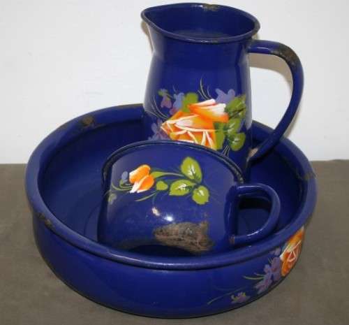 A wonderful vintage dark blue w/ hand painted flowers enamel wash basin, pitcher & chamber pot set.