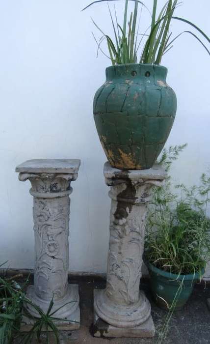 Two lovely concrete pillars. Perfect in a garden or drive way with a statue or plant!!