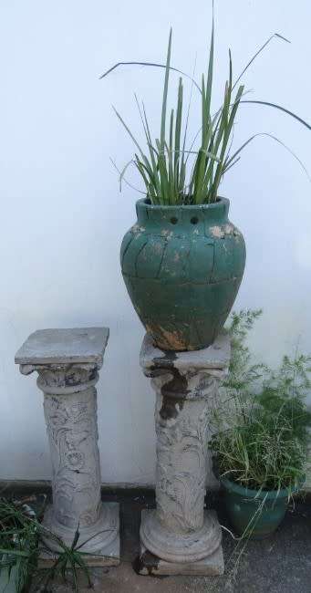 Two lovely concrete pillars. Perfect in a garden or drive way with a statue or plant!!