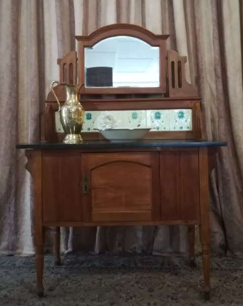 A wonderful vintage solid Oak single door wash stand with a black marble top on castors - stunning!!