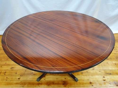An exquisite claw footed Regency style round dining table (134cm x 75cm). Xmas sale