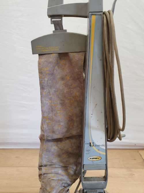 A Kirby vacuum cleaner in working order with extra attachments