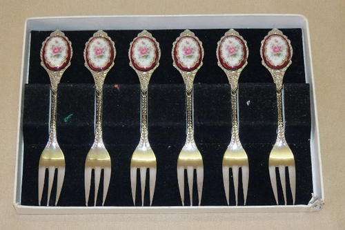 AN AWESOME BOXED SET OF SIX STAINLESS STEEL CAKE FORKS WITH A PORCELAIN INLAY ON THE HANDLE